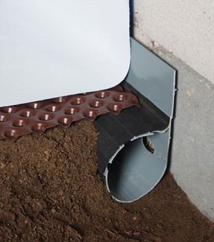 Closeup of a crawl space drainage system installed in Callahan